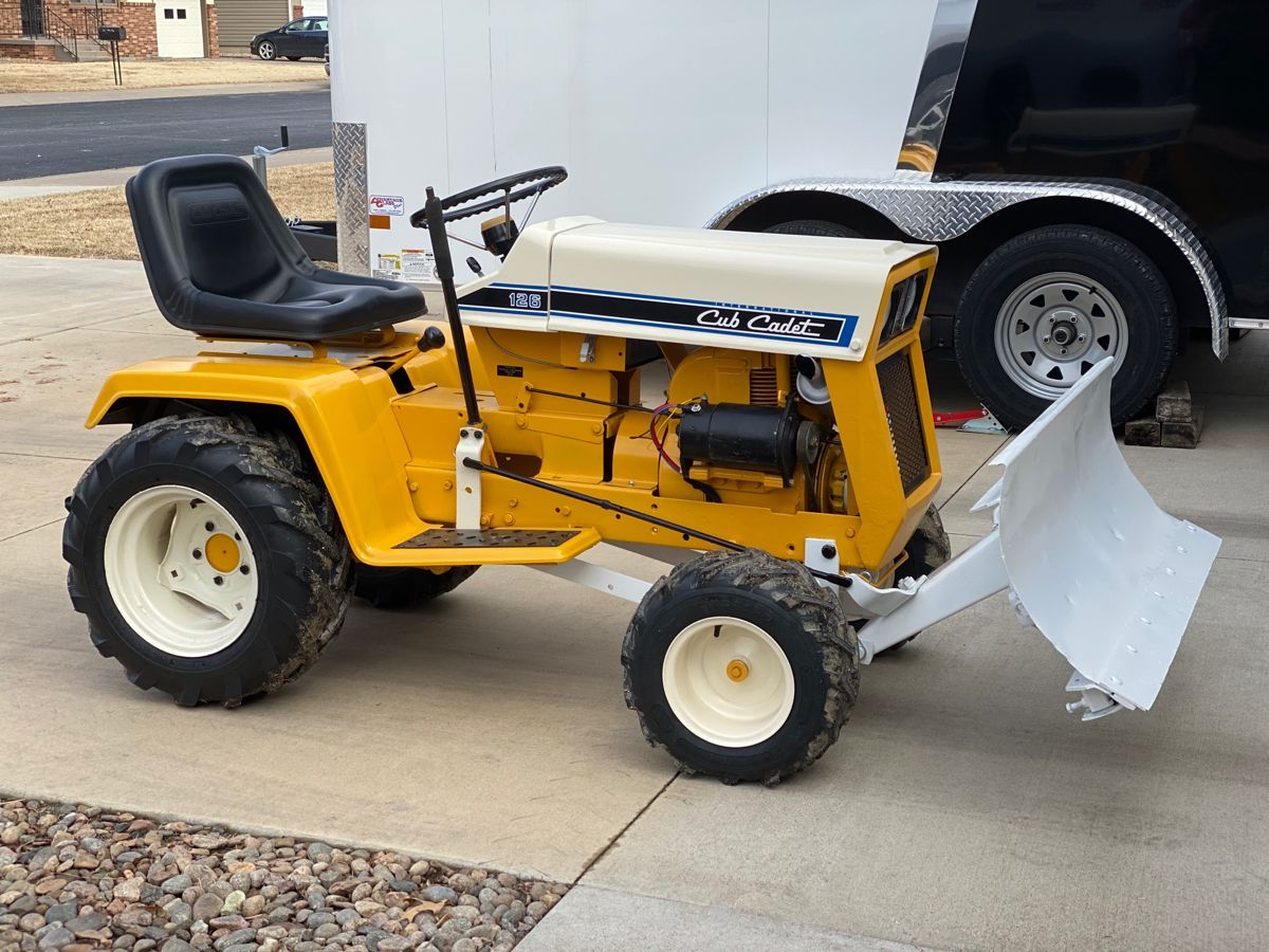 A picture of a Cub Cadet mower with various attachments and accessories